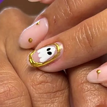 Hand-painted ghost nail art with gold details at Uvabon Nail Salon
