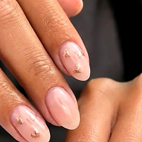 Nude builder gel nails with gold flakes at Uvabon Nail Salon