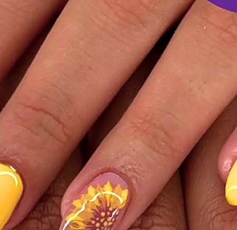 Yellow nails with hand-painted sunflower art at Uvabon Nail Salon
